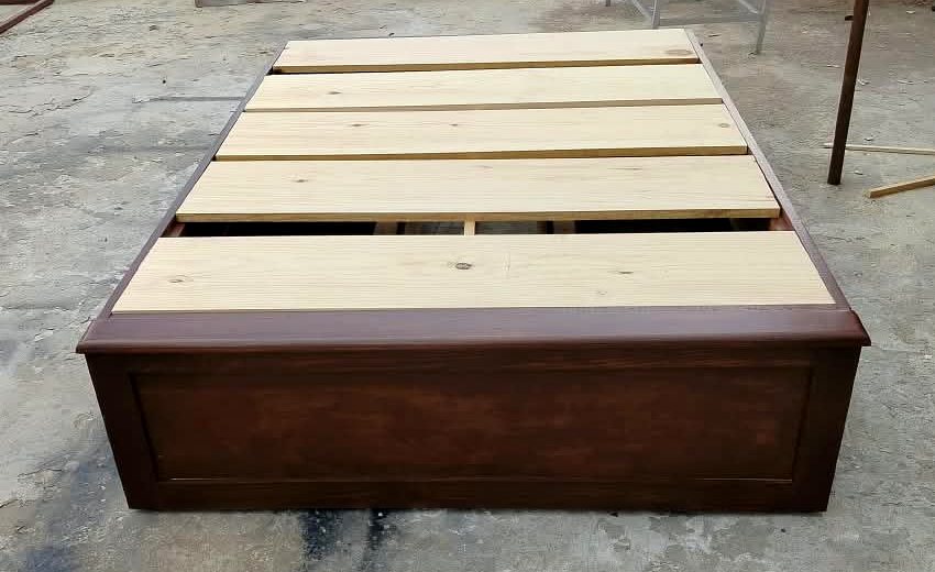Base de cama matrimonial de pino entintado tono nogal claro, vista de frente
